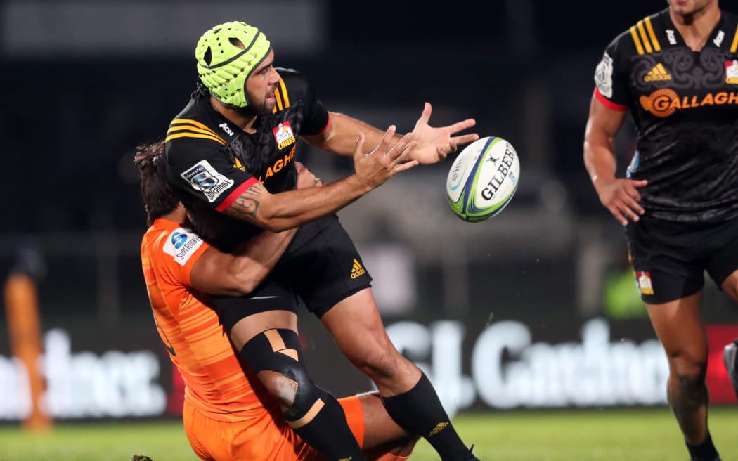 Charlie Ngatai of the Chiefs offloads the ball in a tackle during the Super Rugby match between the Waikato Chiefs and the Jaguares of Argentina at the Rotorua International Stadium.