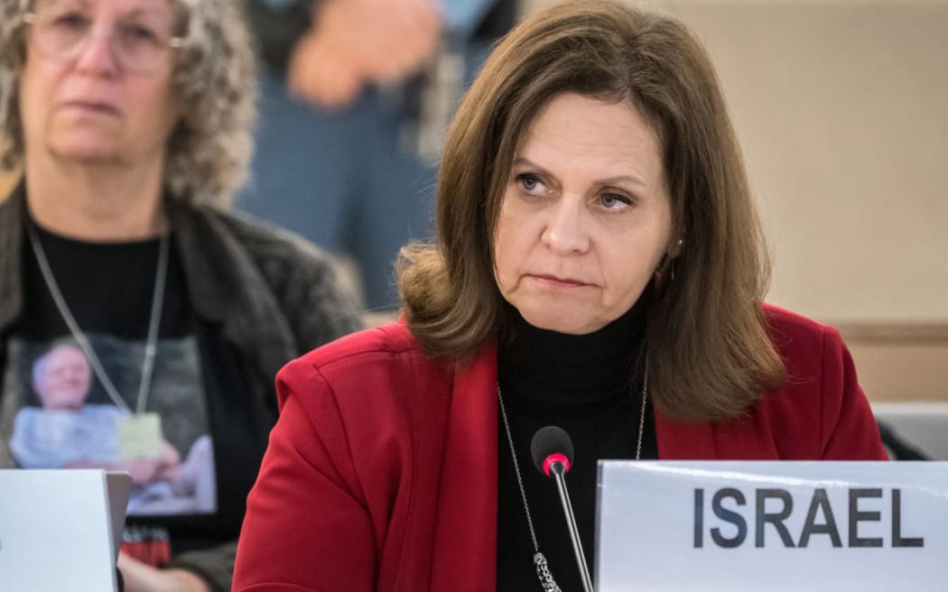 Israel's Ambassador to the UN Meirav Eilon Shahar (R) delivers a speech next to former hostage Aviva Siegel during a session of the situation in the Occupied Palestinian Territory during the 55th session of the Human Rights Council in Geneva on February 29, 2024. Aviva Siegel was released on November 26, 2023, her husband, Keith Siegel, is still being held hostage. (Photo by Fabrice COFFRINI / AFP)