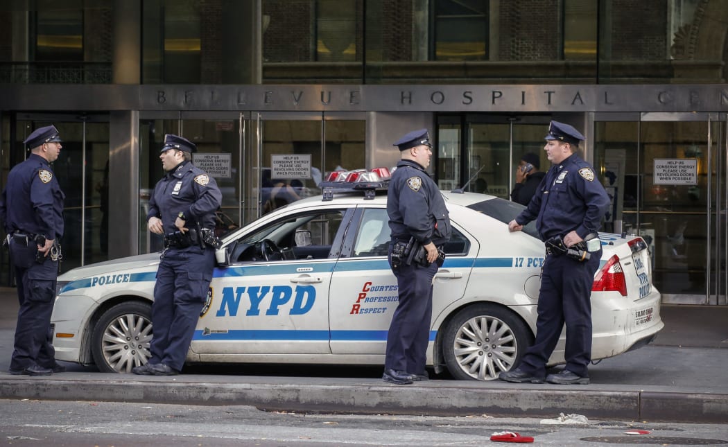 Police officers in front of Bellevue Hospital where Dr Craig Spencer, who was diagnosed with Ebola, remains in quarantine.
