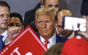 Former US President and Republican presidential hopeful Donald Trump departs after speaking at a "Commit to Caucus" rally in Clinton, Iowa, on January 6, 2024. (Photo by TANNEN MAURY / AFP)