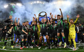 Western United players celebrate with the championship trophy during the A-League Grand Final.