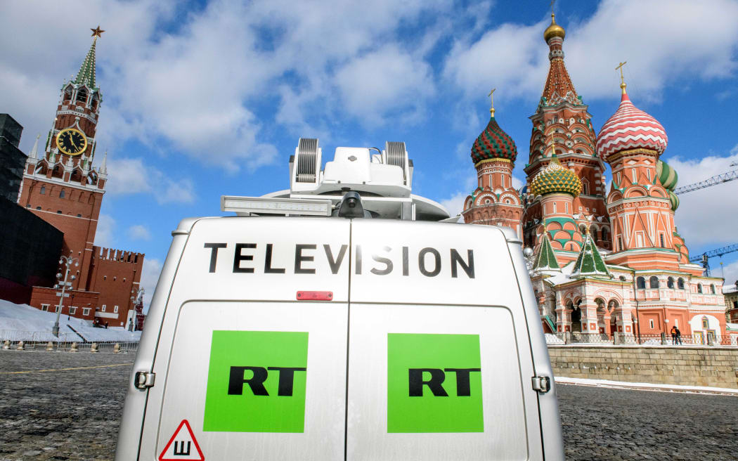 A Russia's state-controlled Russia Today (RT) television broadcast van is seen parked in front of St. Basil's Cathedral.