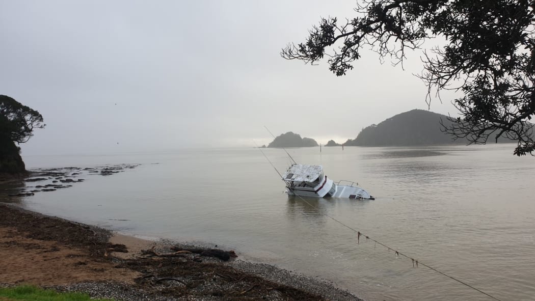 A launch which was knocked off its piles at Waitangi during the wild weather over the weekend drifted to Horotutu Beach in Paihia, where salvage teams have been trying to get it out of the water.