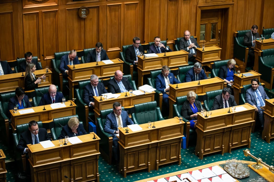 Opposition MPs read through budget documents, take notes, and prepare responses while listening to the Minister of Finance deliver their Budget 2021 statement