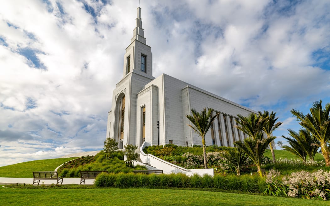 Native landscaping surrounds the temple
