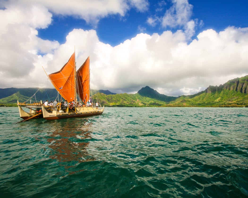 The day breaks over HÅkÅ«leÊ»a with Kualoa behind her.