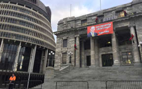 Four protesters got onto the roof, placed solar panels on a ledge and unfurled a banner.