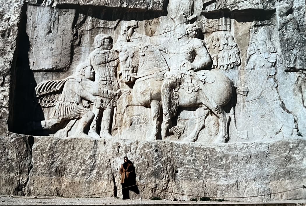 Marjan Neslon in Iran as an adult  standing at the stairway of palace on the Persepolis Terrace