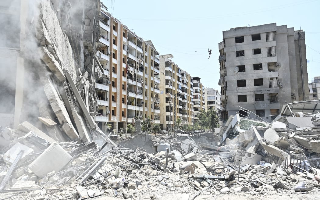 The rubble of a collapsed building is pictured at the site of an overnight Israeli airstrike in the Kafaat neighborhood of Beirut's southern suburbs in Beirut, Lebanon, on June 6, 2025. Israel warns on June 6 that it will keep striking Lebanon until it disarms the militant group Hezbollah, hours after it hits south Beirut in what Lebanese leaders call a major ceasefire violation.  (Photo by Fadel Itani/NurPhoto). (Photo by Fadel Itani / NurPhoto via AFP)