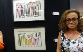 Professor Michelle Erai next to the print she bought this year.