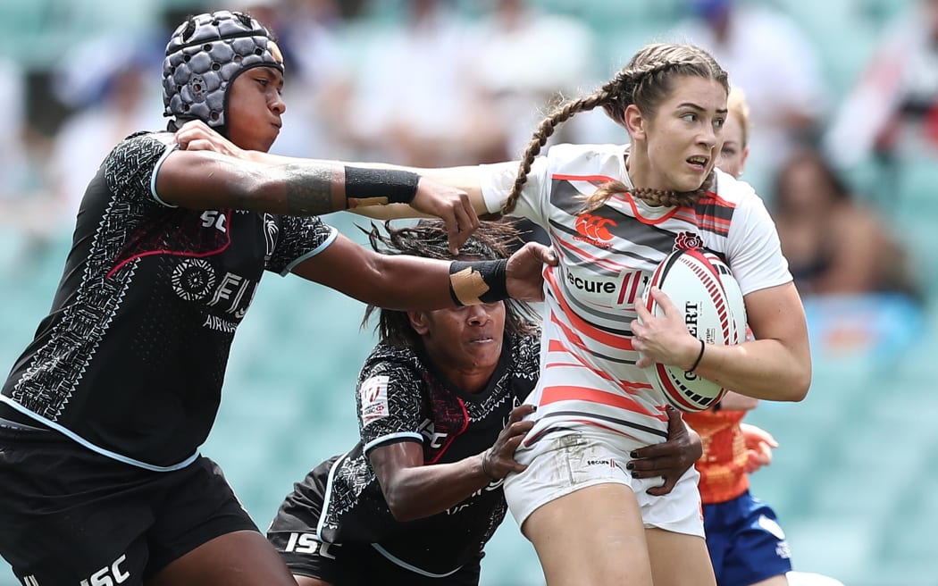 England's Holly Aitchison fends off the Fiji defense at the Sydney 7s.