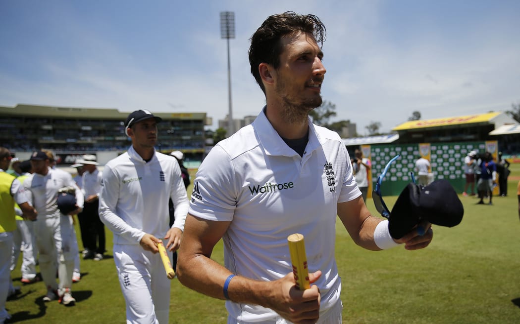England fast bowler Steven Finn acknowledges the crowd as he leaves the grounds at the end of the first Test match against South Africa at Kingsmead Stadium in Durban on December 30, 2015.
