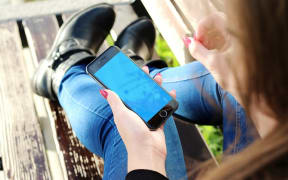 Young woman on her iPhone