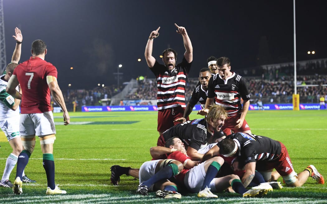 Sam Anderson-Heather scores a try for the Barbarians as his team mates celebrate.