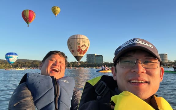 Eric Vu and William Lam were kayaking on Lake Burley Griffin when they had a close encounter with a hot air balloon.