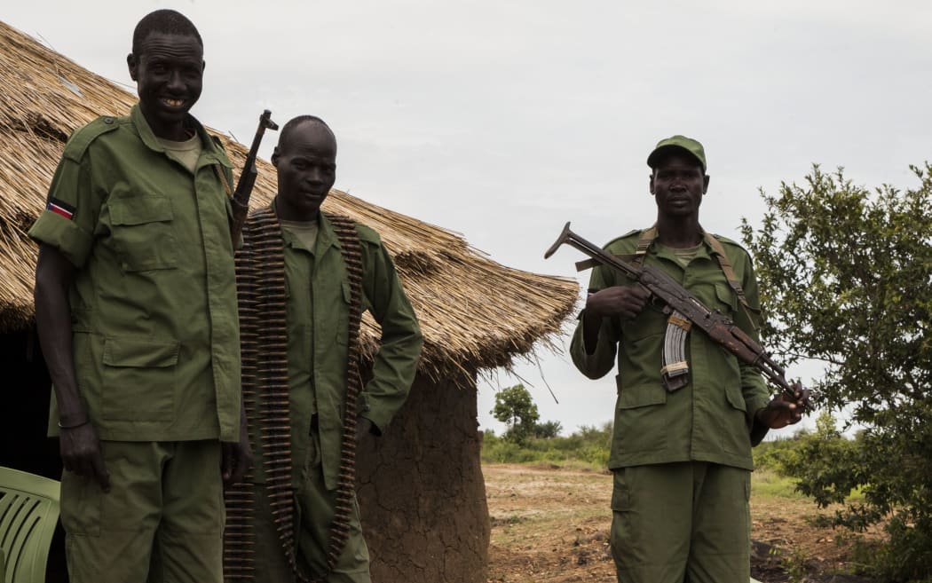 SPLA-IO soldiers stand on in a camp on the outskirts of the capital, Juba, at the foot of Jebel Dinka, before simple mud hut in South Sudan, 22 June 2016. A peace agreement has provided a way for the integration of former rebels into the armed forces (SPLA).