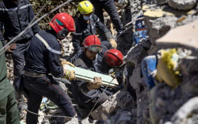 Moroccan and Spanish rescuers search the rubble for survivors in Talat N'Yacoub village of al-Haouz province in earthquake-hit Morocco on September 11, 2023. Moroccan rescuers supported by newly-arrived foreign teams on September 11 faced an intensifying race against time to dig out any survivors from the rubble of mountain villages, on the third day after the country's strongest-ever earthquake.