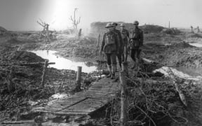 1994-3346 Duckboards, wire at Carter Point 1917 - Soldiers on duckboards among wire and mud at Carter Point, 1917.