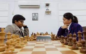 Chess player Sai and Luna Lu are playing in the Auckland chess center.