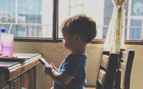 small boy on phone