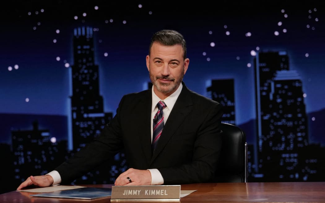 (FILES) This handout image released by Disney on September 24, 2025, shows Jimmy Kimmel during the taping of "Jimmy Kimmel Live!" at the Capitan Entertainment Centre on September 23, 2025, in Los Angeles, California. Sinclair, one of the companies that began boycotting comedian Jimmy Kimmel after US government pressure said on September 26, 2025 that it would start broadcasting his show again. Disney-owned ABC took the late-night host off the air when Sinclair and another firm said they would no longer show his programme on the dozens of stations they own, purportedly over remarks the comedian made in the wake of the murder of right wing activist Charlie Kirk.