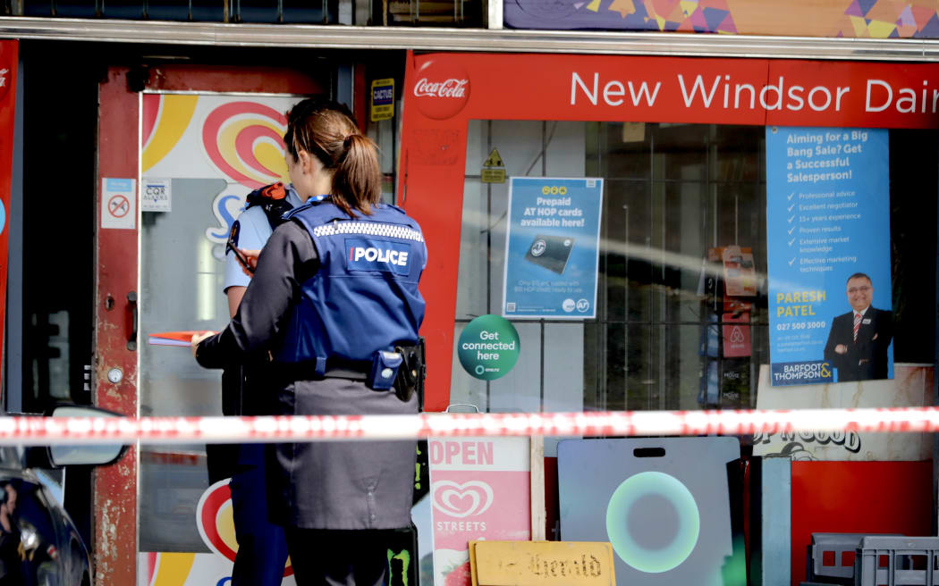 Police officers outside the New Windsor Dairy in Auckland on 5 October 2023.