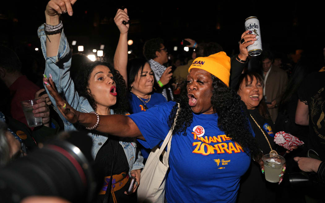 Supporters of New York City Mayoral candidate Zohran Mamdani celebrate during an  election night event at the Brooklyn Paramount Theater in Brooklyn, New York on November 4, 2025. (Photo by Angelina Katsanis / AFP)