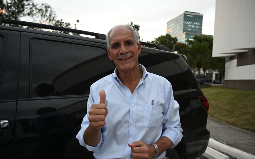 Honduran presidential candidate and businessman Nasry Asfura of the opposition National Party gives a thumbs-up as he leaves after a meeting with business leaders in Tegucigalpa on November 28, 2025. Asfura told AFP that he has "no connection whatsoever" with former president Juan Orlando Hernandez, who is imprisoned in the United States on drug trafficking charges and was pardoned on Friday by President Donald Trump. (Photo by Orlando SIERRA / AFP)