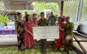 Ebeye resident Leilani Kemem, second from right front, receives the first loan at a ceremony earlier this month on Ebeye. Delivering the US$5,000 business loan are Kora Fund Chair Amenta Matthew and Taiwan Embassy Deputy Chief of Mission Mars Wang.
