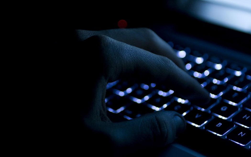 Hand on keyboard at night