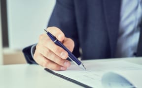 Businessman reading contract before making a deal.