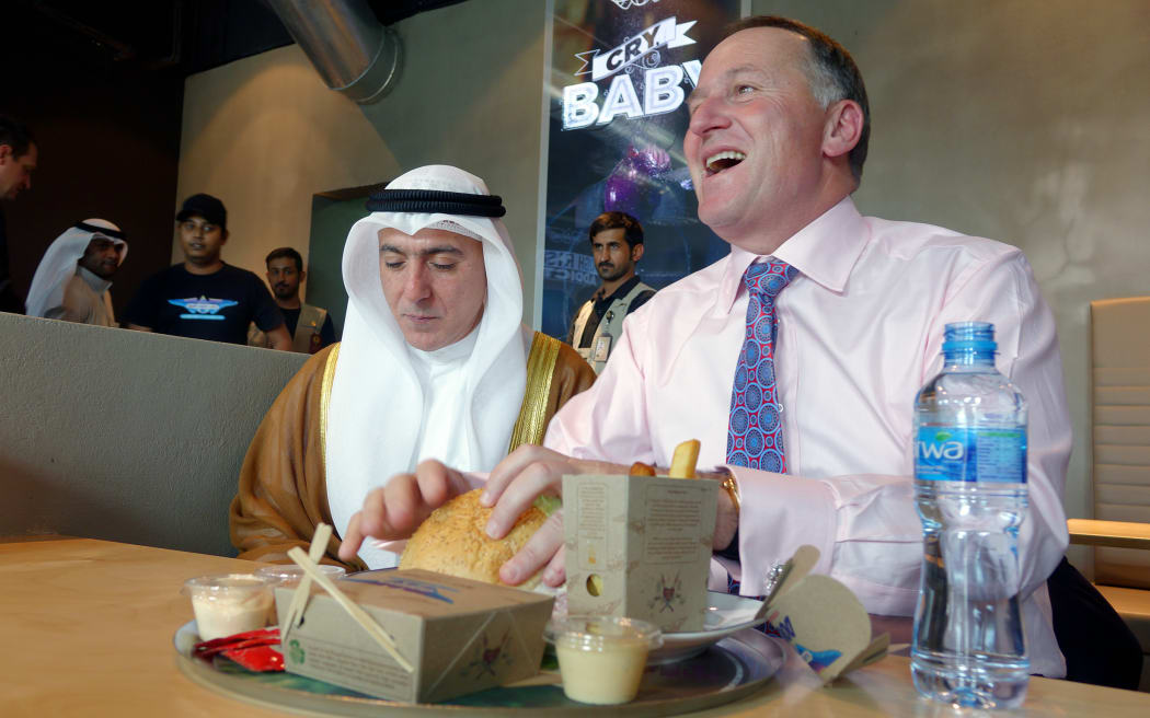 John Key orders a burger from New Zealand company BurgerFuel in Kuwait