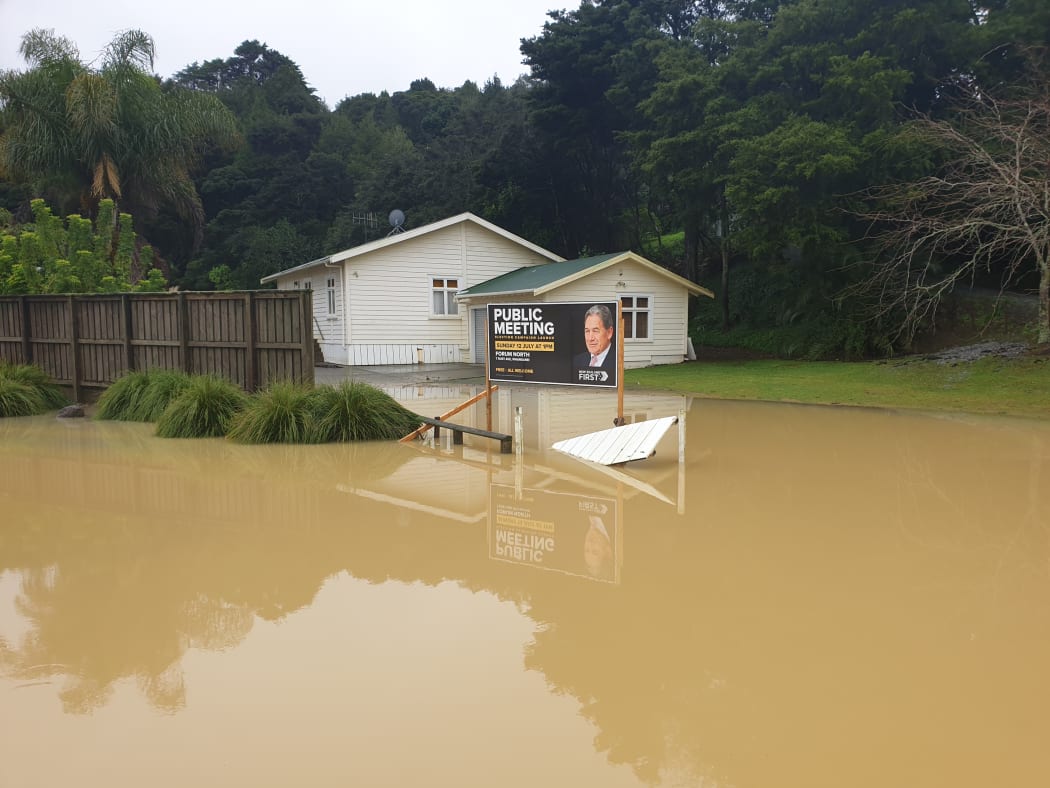 Northland flooding with a New Zealand First billboard.