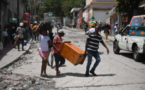 Resident evacuate the Carrefour Feuilles commune in Port-au-Prince, Haiti, on 15 August 15, 2023, as gang violence continues to plague the Haitian capital.