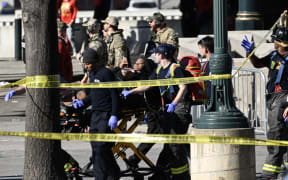 First responders tend to an injured person as they bring her out of Union Station near the Kansas City Chiefs' Super Bowl LVIII victory parade on February 14, 2024, in Kansas City, Missouri. Multiple people were injured after gunfire erupted at the Kansas City Chiefs Super Bowl victory rally on Wednesday, local police said. (Photo by ANDREW CABALLERO-REYNOLDS / AFP)