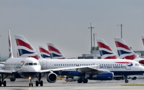 British Airways passenger aircraft are pictured at London Heathrow Airport, west of London on May 3, 2019. -