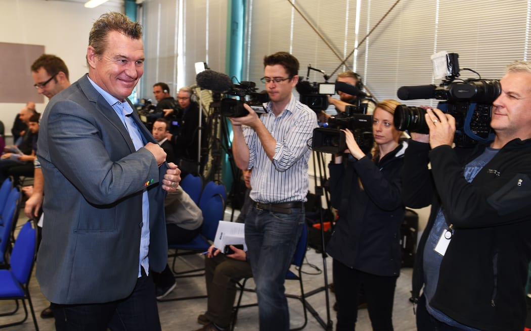Sir John Kirwan smiles as he leaves the media conference announcing his resignation