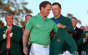 2016 Masters champion Danny Willett receives his Green Jacket from last year's winner Jordan Spieth.