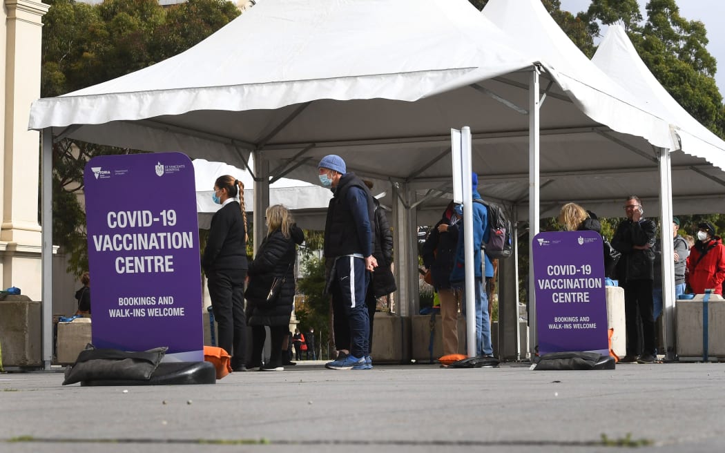 People wait in queues at a Covid-19 vaccination centre in Melbourne on May 26, 2021, as Australia's second biggest city scrambles to contain a growing Covid outbreak. (Photo by William WEST / AFP)