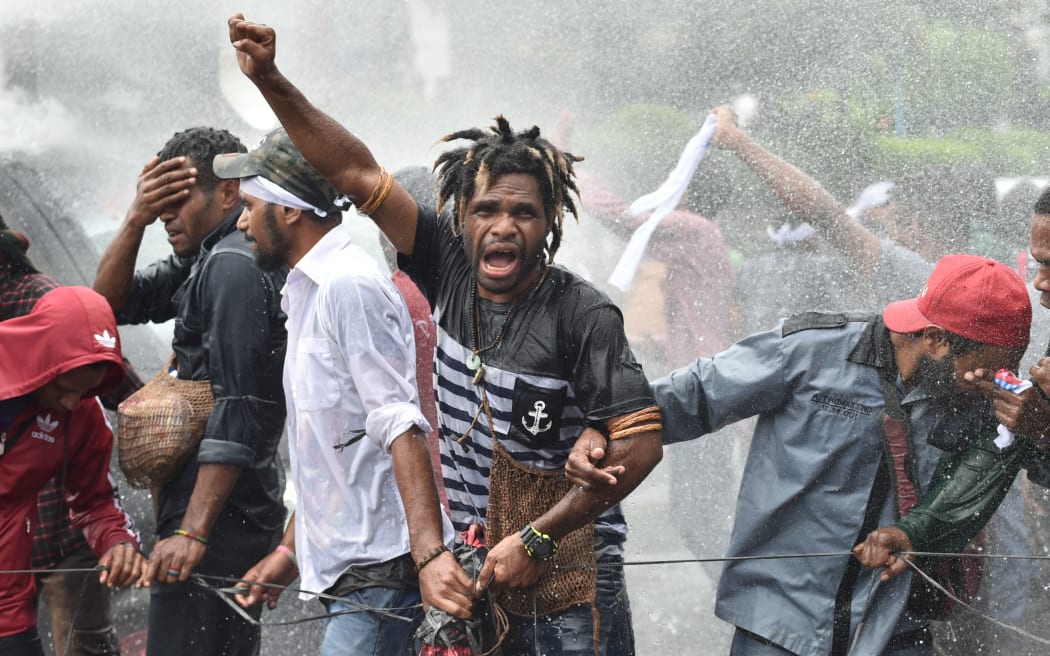Protesters are resisting police using water cannons during a protest by mostly university students from Free Papua Organization and the Papua Student Alliance in Jakarta on December 1, 2016.