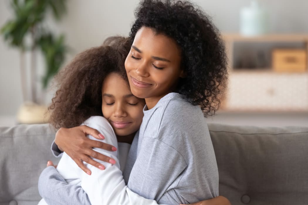 Mother embracing daughter, love, nurture and care. (File photo)