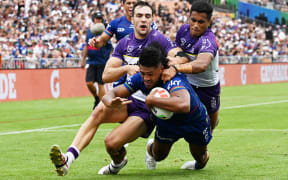 Ali Leiataua of the Warriors scores against Melbourne Storm.