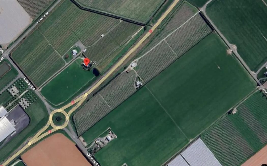 A service station on the corner of Evenden Road and State Highway 2 is surrounded by horticulture.