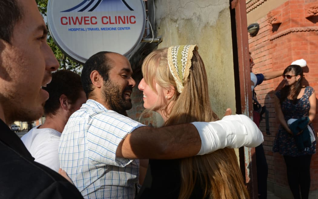 An Israeli Himalayan snowstorm survivor, treated for frostbite, talks to compatriots after being discharged from a hospital.