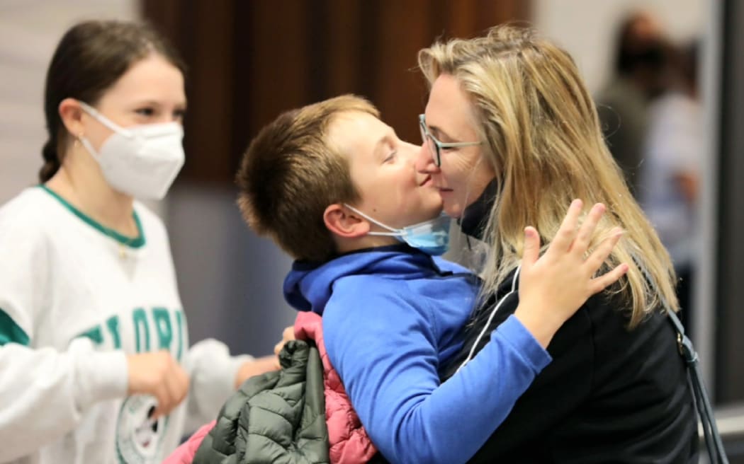 Travellers reunite as borders open to vaccinated travellers from more countries on 2 May 2022.