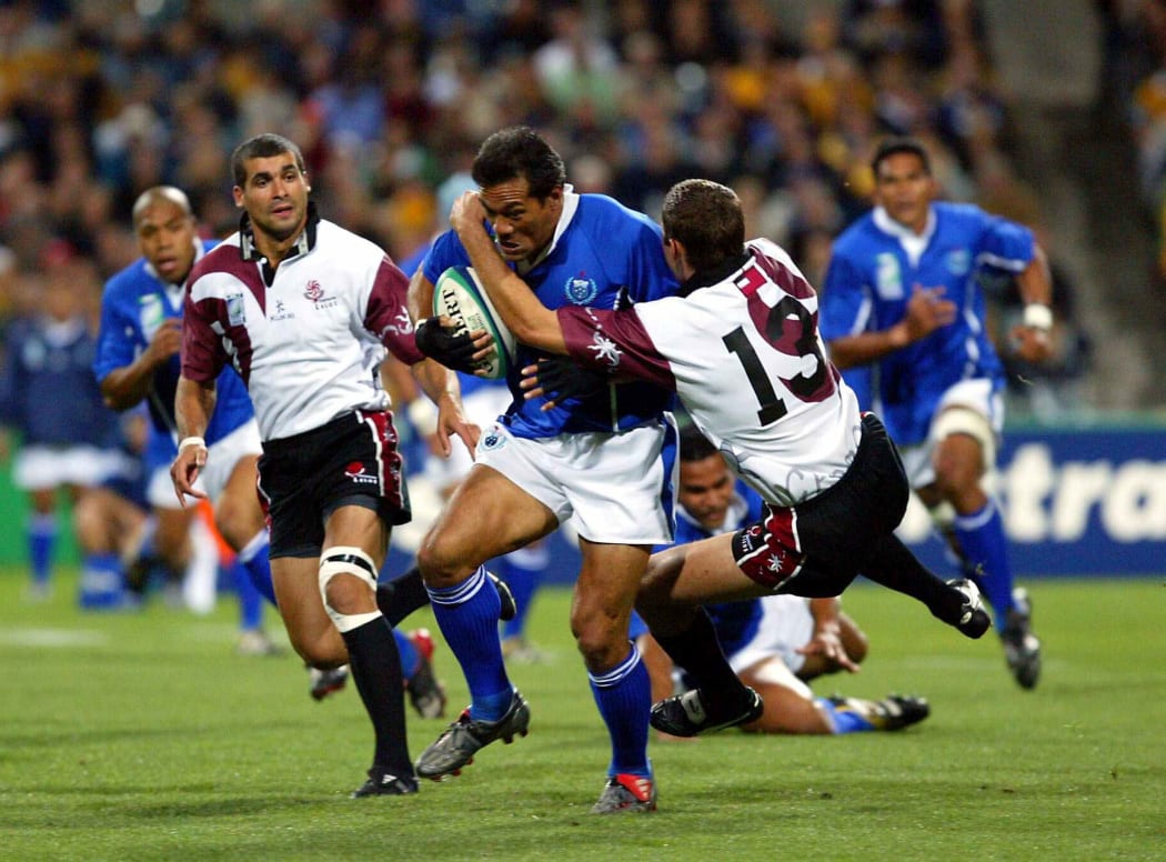 Manu Samoa's Brian Lima is tackled by the Georgian defence at the 2003 Rugby World Cup.
