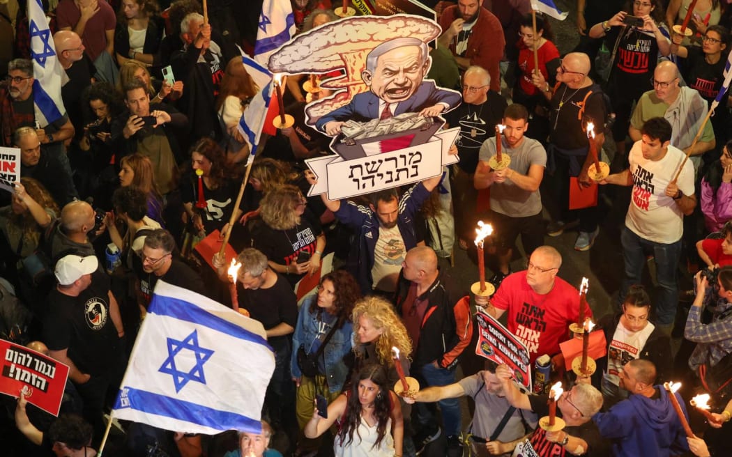 Relatives and supporters of Israeli hostages held in Gaza since the October 7 attacks by Hamas militants hold placards, wave Israeli flags and hold a caricature of Israeli Prime Minister Benjamin Netanyahu during a demonstration in front of the Defence Ministry in the Israeli coastal city of Tel Aviv, on 6 April, 2024.