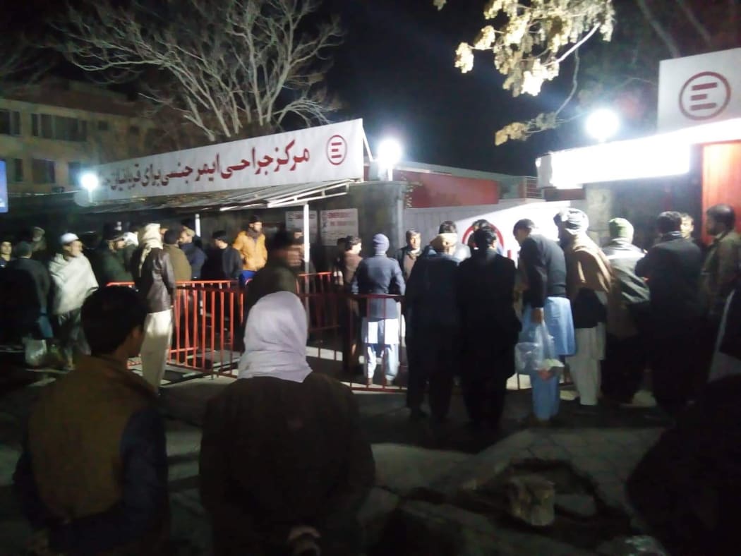 Relatives of blast victims gather outside a hospital of the Italian aid organisation 'Emergency' in Kabul, following a blast at a meeting of top clerics in the Afghan capital.