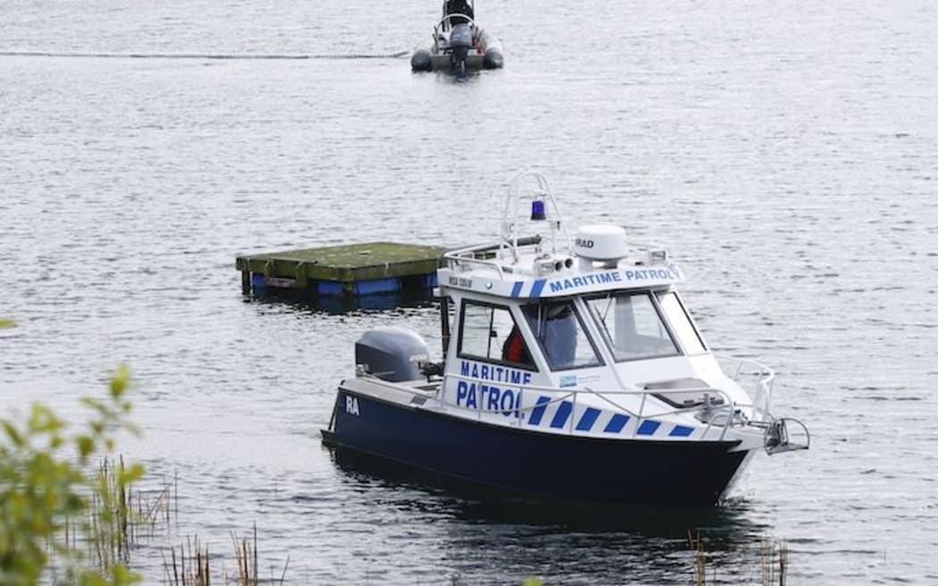 The police dive squad help to recover a car that plunged into Lake Rotoma on Saturday.