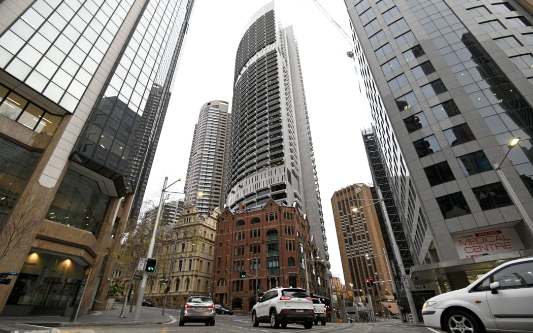 An afternoon thin traffic makes its way through the quiet central business district of in Sydney on 23, 2021, amid a coronavirus outbreak that state leaders said has become a "national emergency". (Photo by Saeed KHAN / AFP)